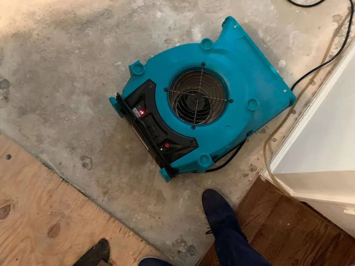 Air mover drying subfloor during Commercial Water Damage Restoration in Oro Valley